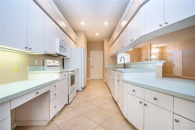 a large kitchen with stainless steel appliances lots of counter space sink and cabinets