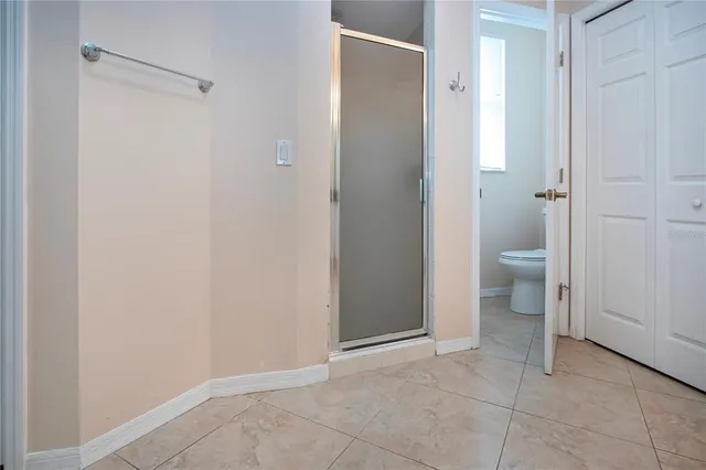 a bathroom view of a toilet and a shower