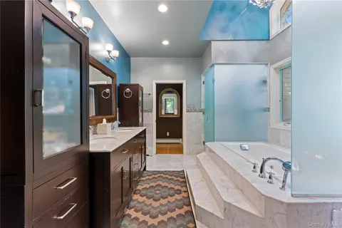 a bathroom with a granite countertop double vanity sink and a mirror