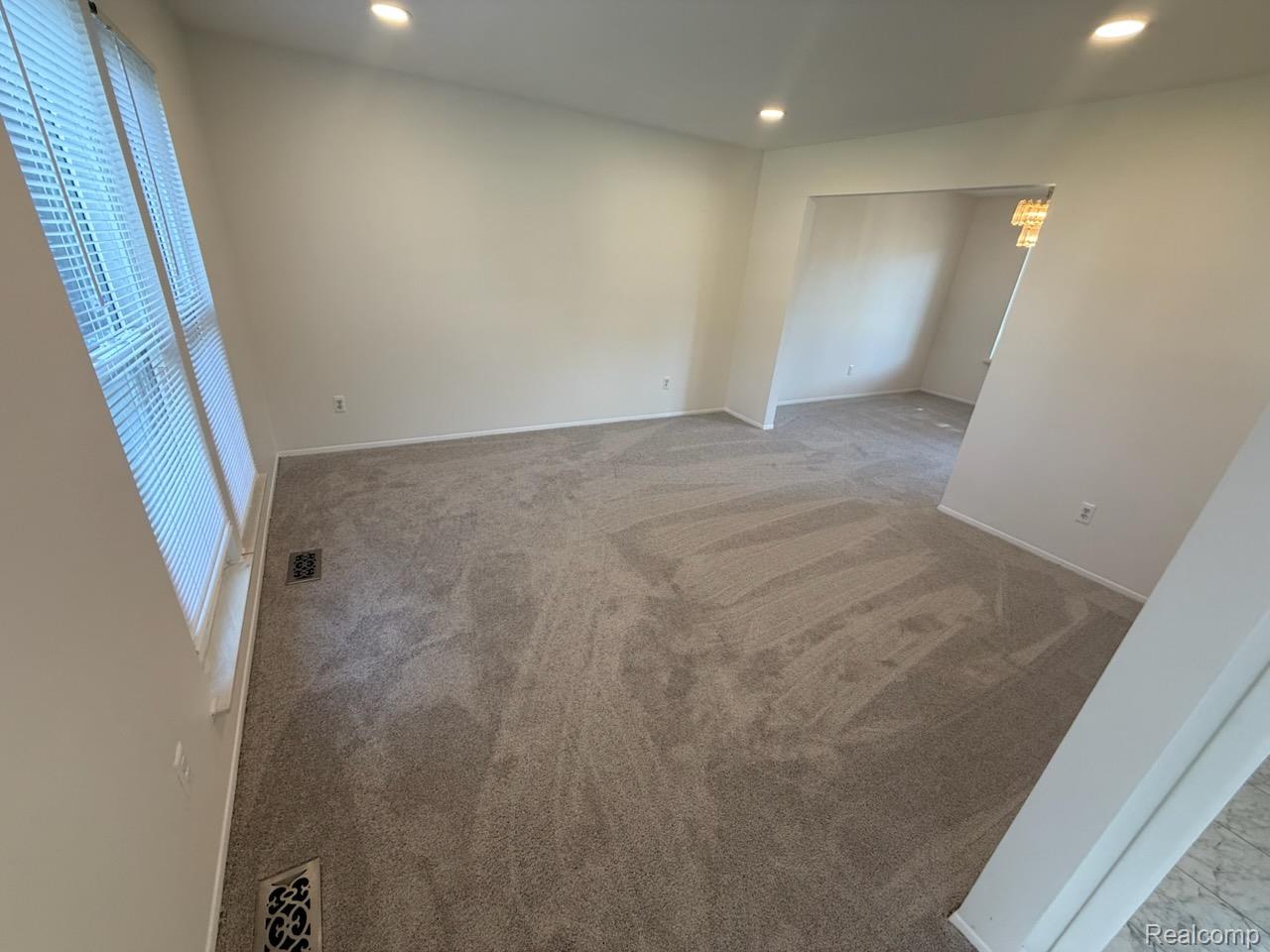28144 Yorktown Road Farmington, MI 48331 - Photo 2 of 25 Spacious room featuring new carpeting, recessed lighting, and a large window with blinds