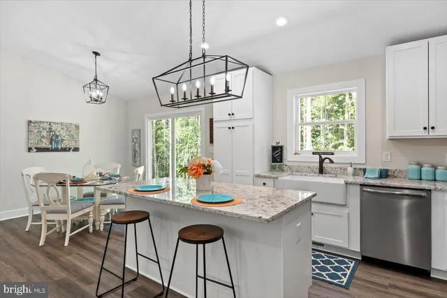 a kitchen with a center island a window and cabinets