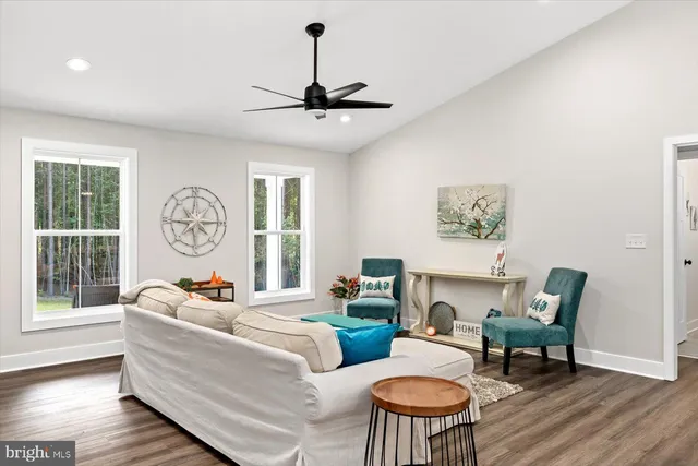 a living room with furniture a window and a chandelier