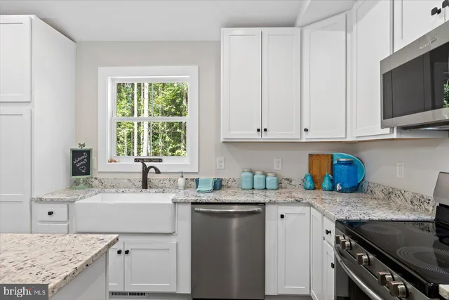 a kitchen with a sink stove and microwave