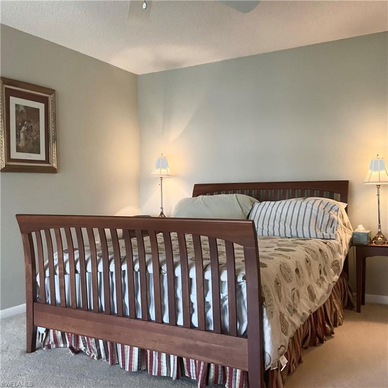 1165 Clam Court, Unit 7 Naples, FL 34102 - Photo 17 of 34 a bedroom with a bed with wooden floor