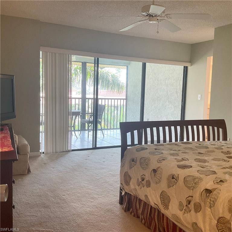 1165 Clam Court, Unit 7 Naples, FL 34102 - Photo 18 of 34 a large bedroom with a bed next to a window
