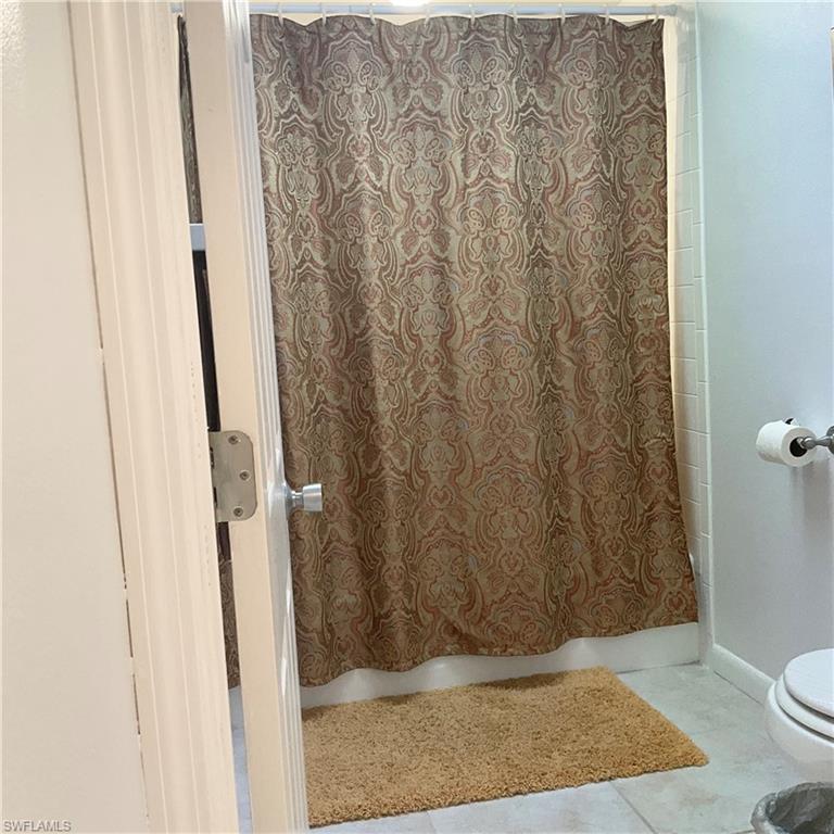 1165 Clam Court, Unit 7 Naples, FL 34102 - Photo 19 of 34 a bathroom with a shower and a toilet