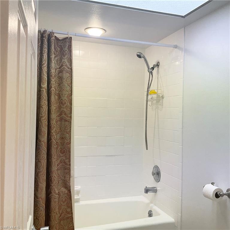 1165 Clam Court, Unit 7 Naples, FL 34102 - Photo 20 of 34 a bathroom with a shower and a bath tub