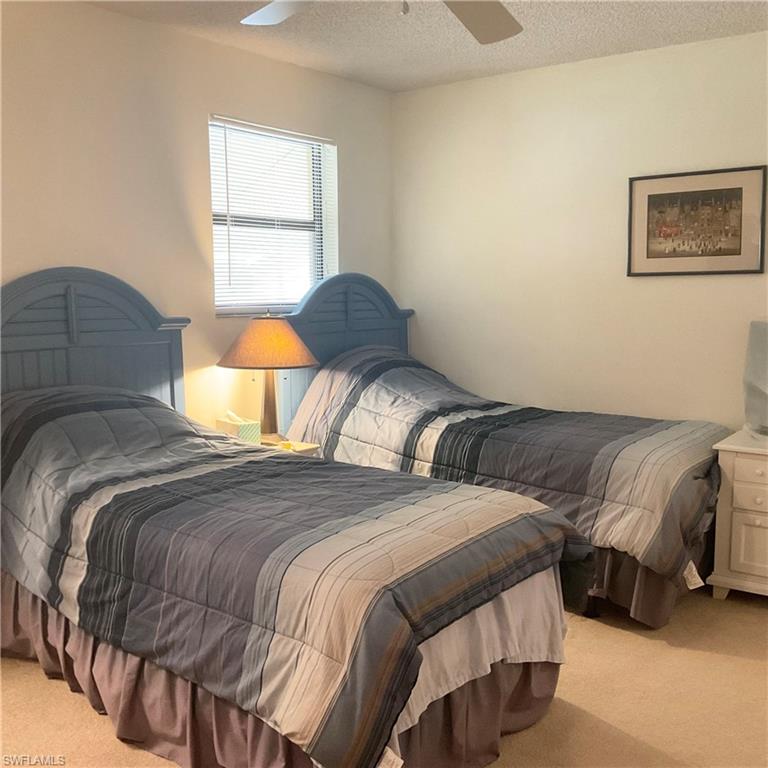 1165 Clam Court, Unit 7 Naples, FL 34102 - Photo 25 of 34 a bedroom with a bed and a window