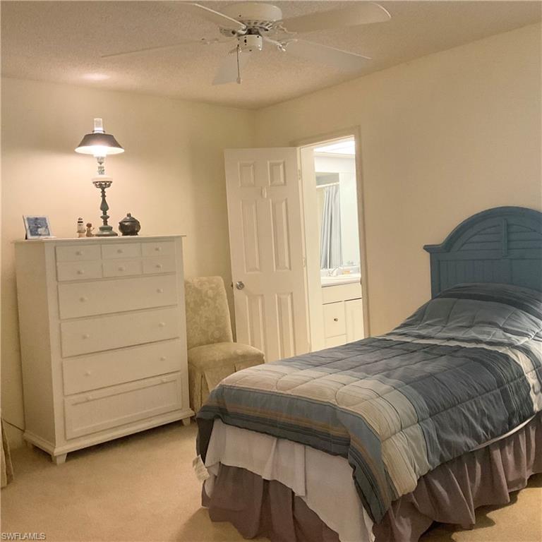 1165 Clam Court, Unit 7 Naples, FL 34102 - Photo 27 of 34 a bedroom with a bed and a dresser