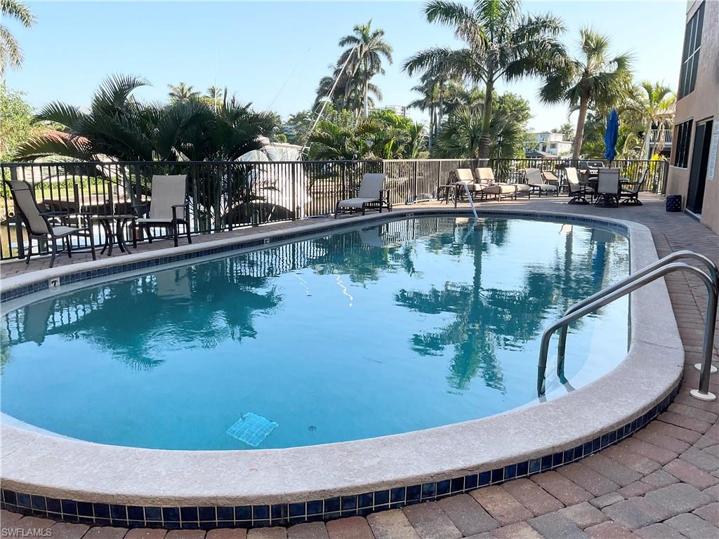 1165 Clam Court, Unit 7 Naples, FL 34102 - Photo 30 of 34 a view of a swimming pool with a lake view
