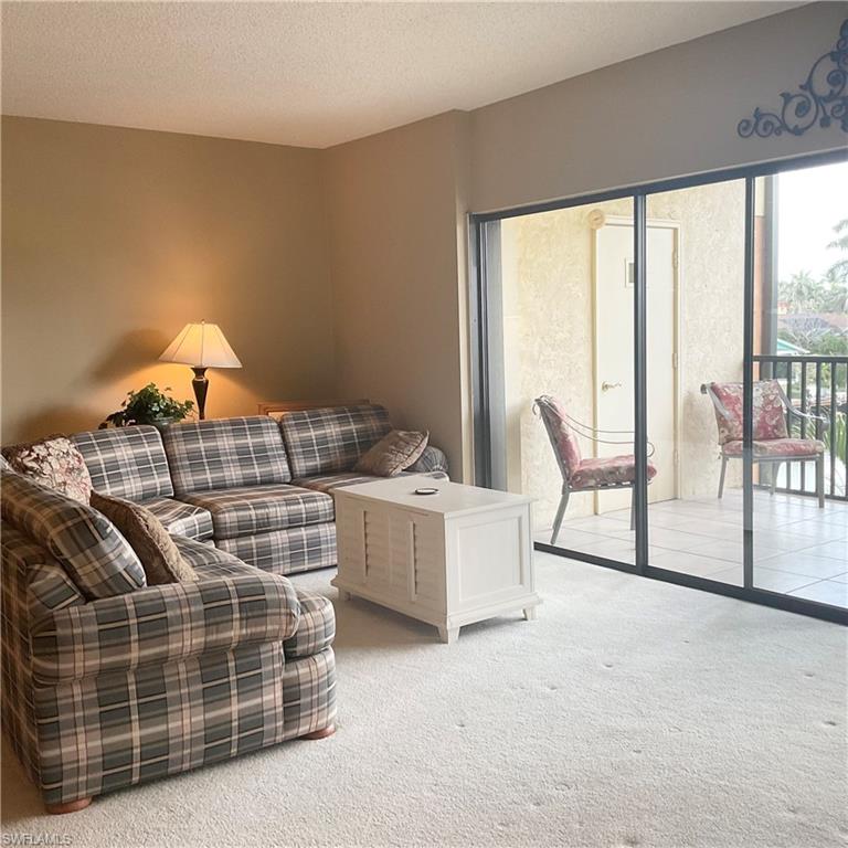 1165 Clam Court, Unit 7 Naples, FL 34102 - Photo 6 of 34 a living room with furniture