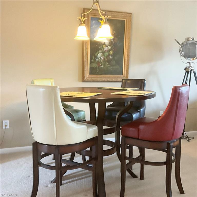 1165 Clam Court, Unit 7 Naples, FL 34102 - Photo 8 of 34 a dining room with furniture and window