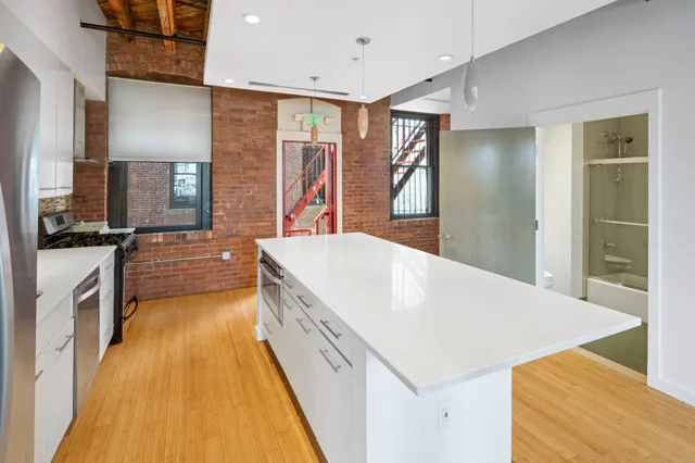 a large white kitchen with a large window