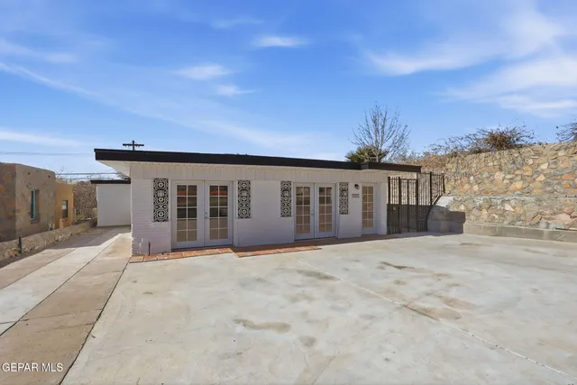 a view of a room with wooden floor and wall painting