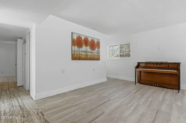 a kitchen with granite countertop white cabinets and sink