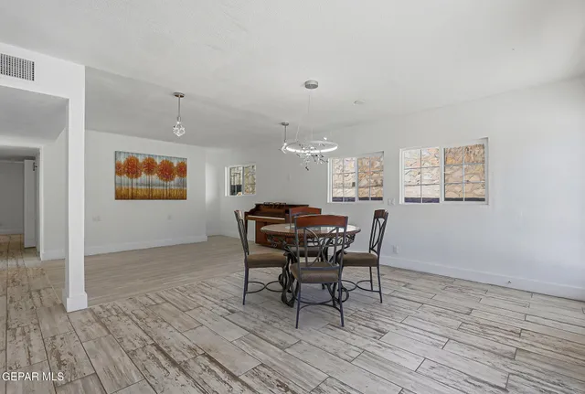 a view of empty room with wooden floor and ceiling fan