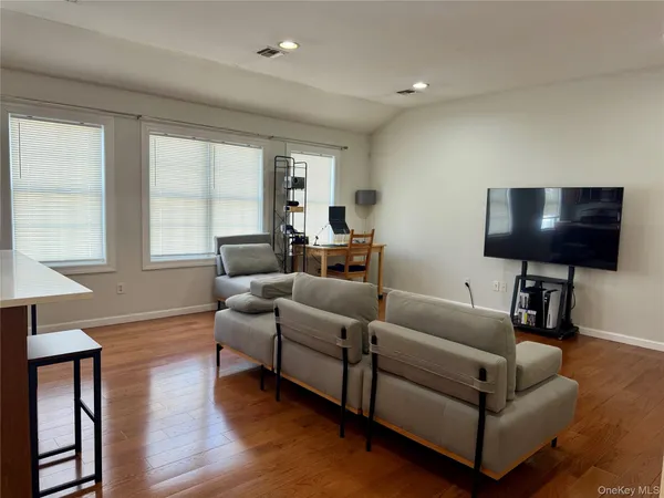a kitchen with a refrigerator a stove a sink a dining table and chairs