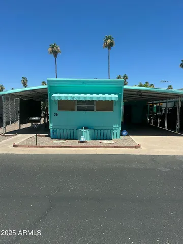 a front view of a house with a garden and yard
