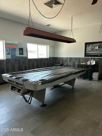 a living room with furniture pool table and a fireplace