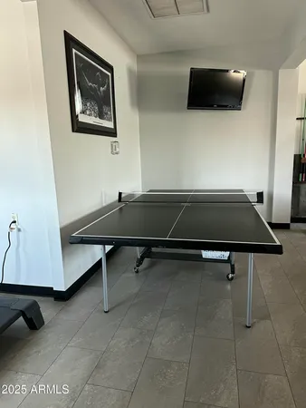 a room with pool table and windows