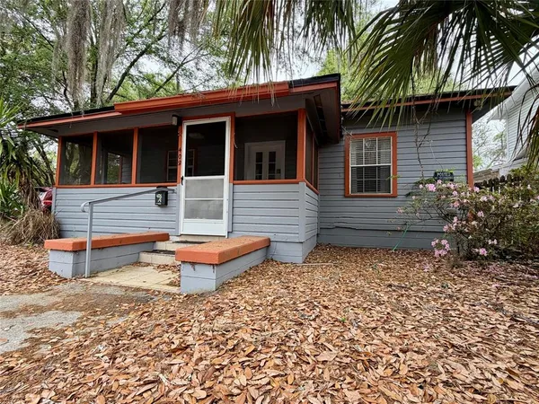 a backyard of a house with outdoor seating
