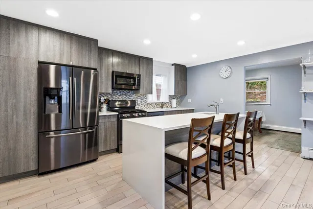 a kitchen with a sink stove and refrigerator