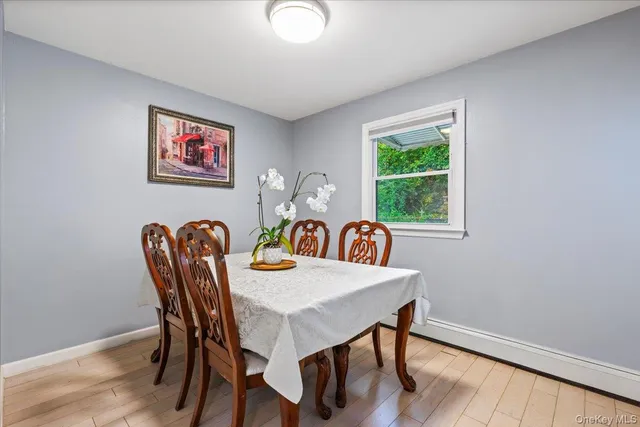 a view of a dining room with furniture window and wooden floor