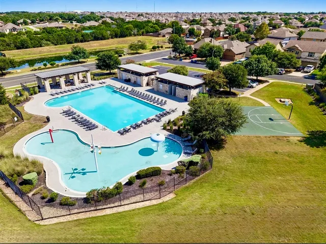 an aerial view of a house with a swimming pool yard and outdoor seating