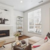 a living room with furniture a fireplace and a window