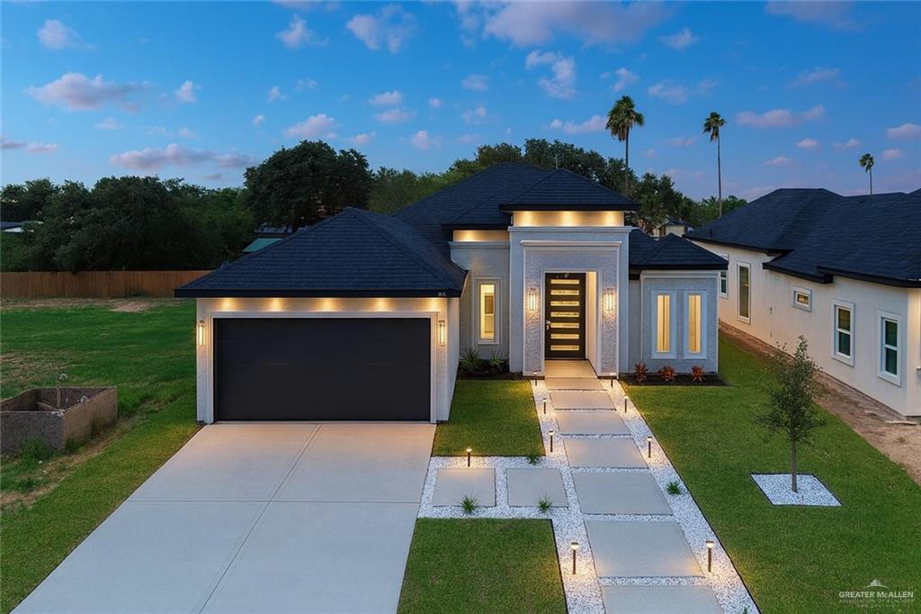 4812 Duke Avenue McAllen, TX 78504 - Photo 1 of 42 a front view of a house with a yard