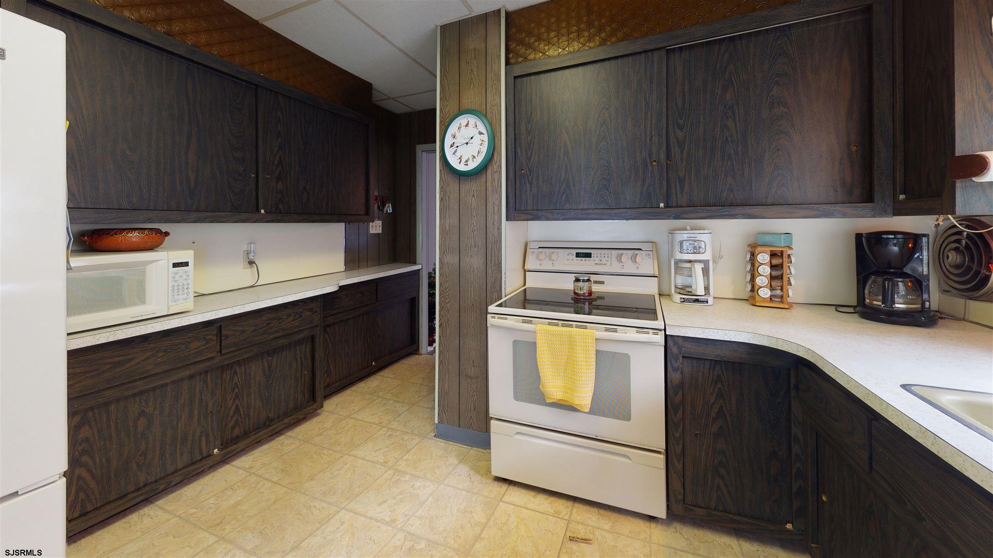 613 3rd Street Somers Point, NJ 08244 - Photo 11 of 22 a kitchen with stainless steel appliances a stove a sink and a microwave