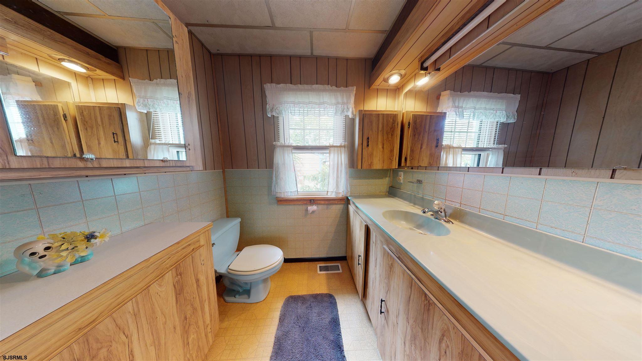 613 3rd Street Somers Point, NJ 08244 - Photo 14 of 22 a bathroom with a sink and a mirror