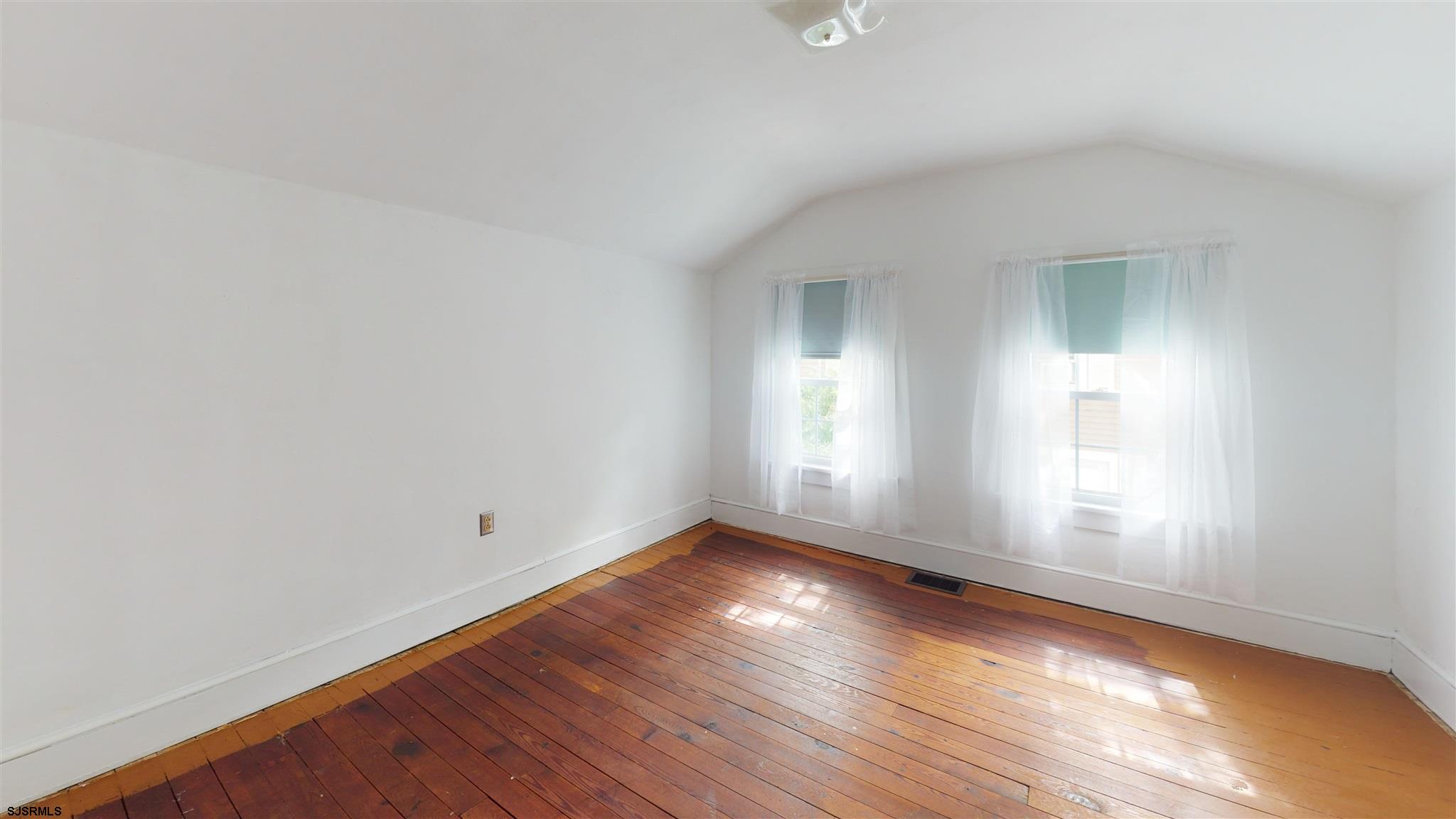 613 3rd Street Somers Point, NJ 08244 - Photo 18 of 22 an empty room with wooden floor and windows