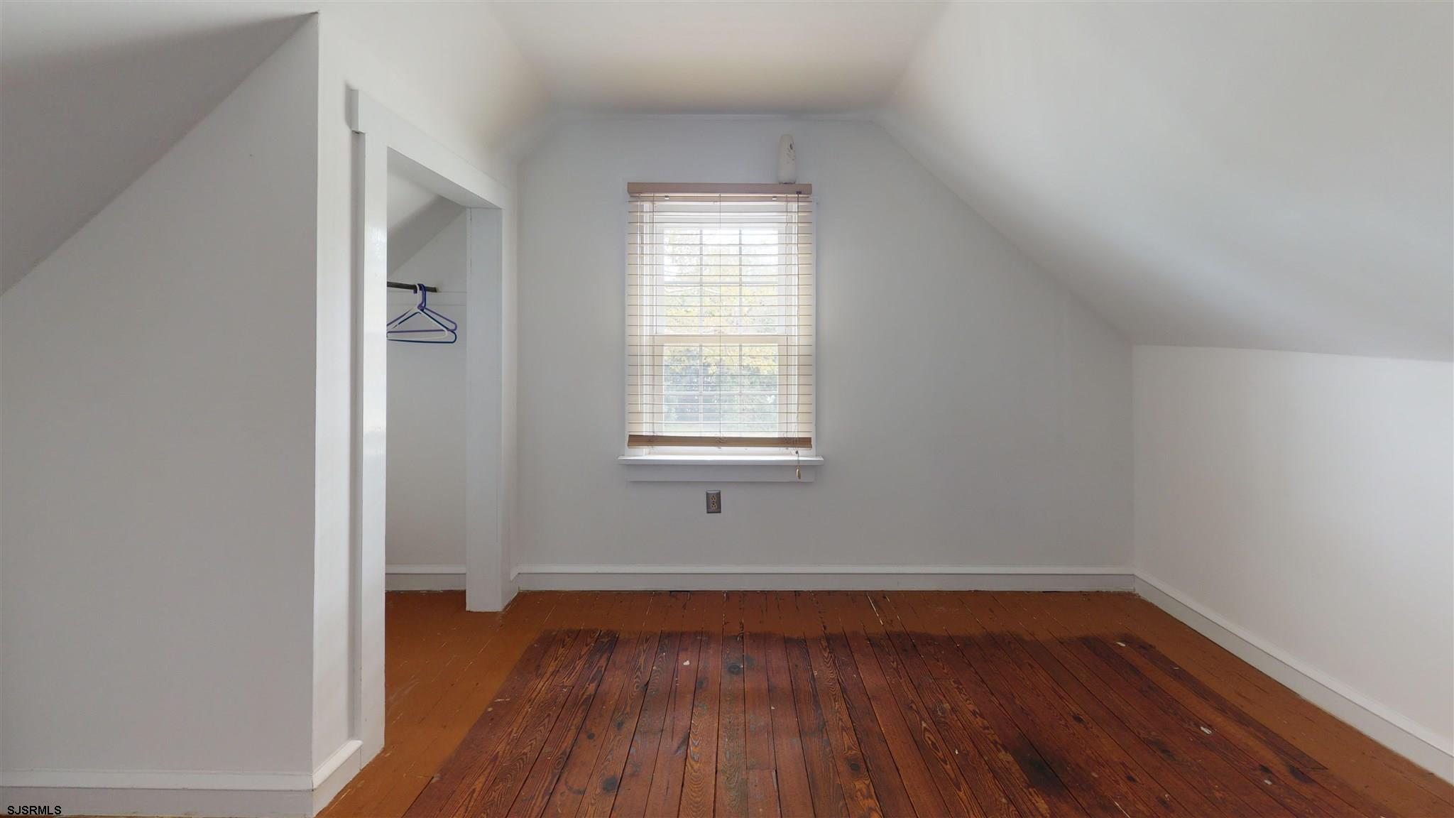 613 3rd Street Somers Point, NJ 08244 - Photo 19 of 22 an empty room with wooden floor and windows