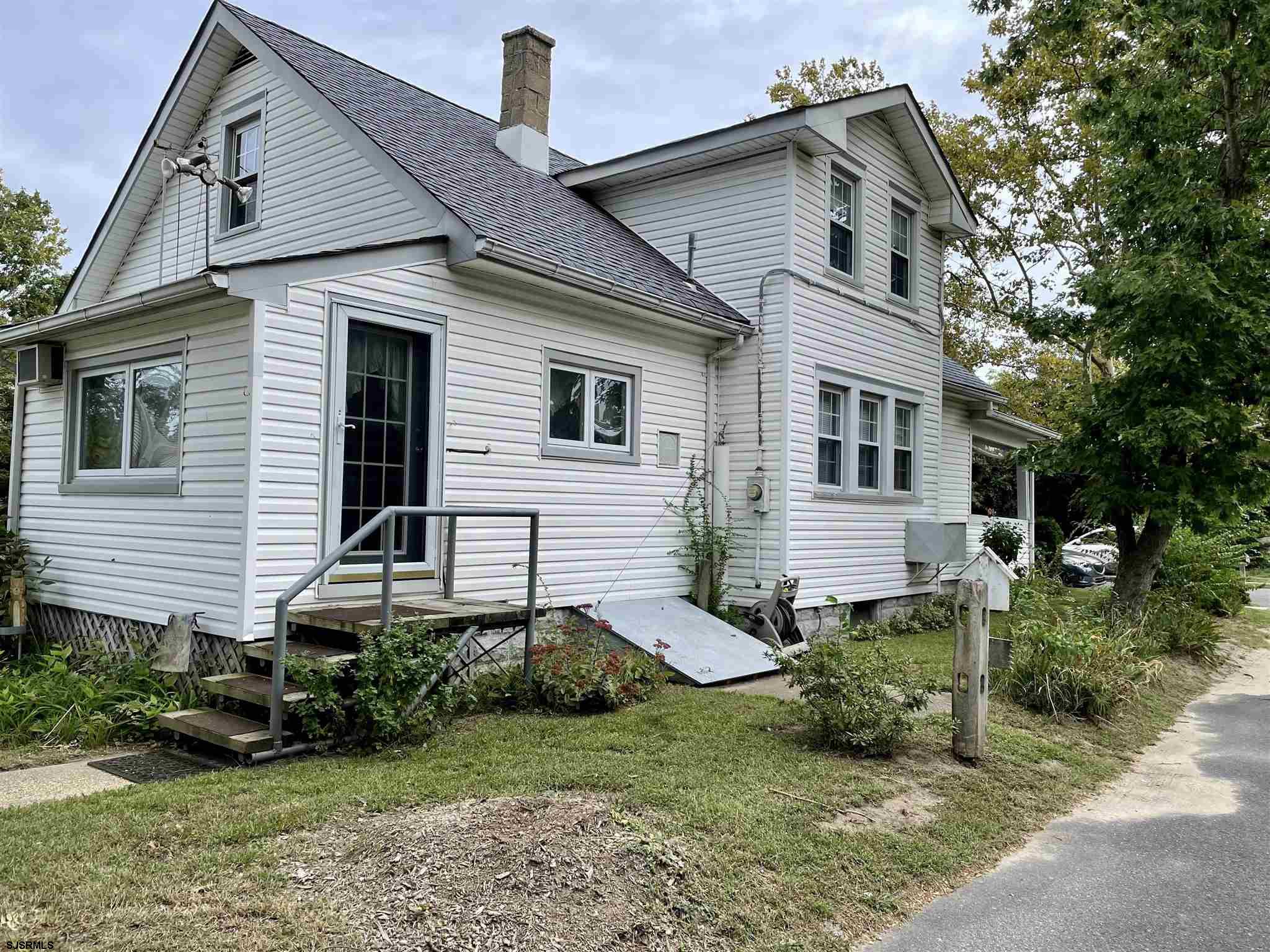 613 3rd Street Somers Point, NJ 08244 - Photo 3 of 22 a front view of a house with a garden