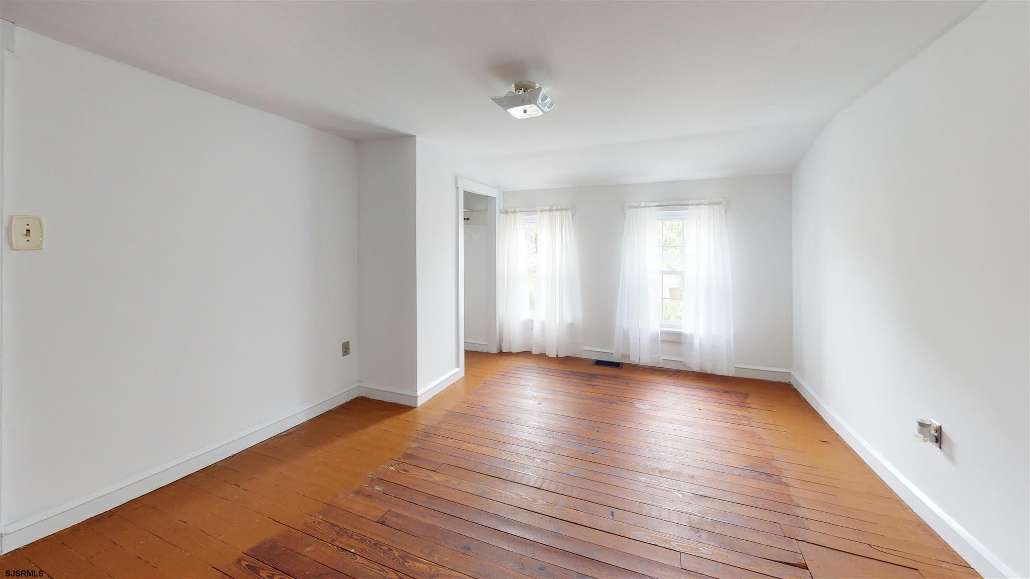 613 3rd Street Somers Point, NJ 08244 - Photo 21 of 22 a view of an empty room with wooden floor and window