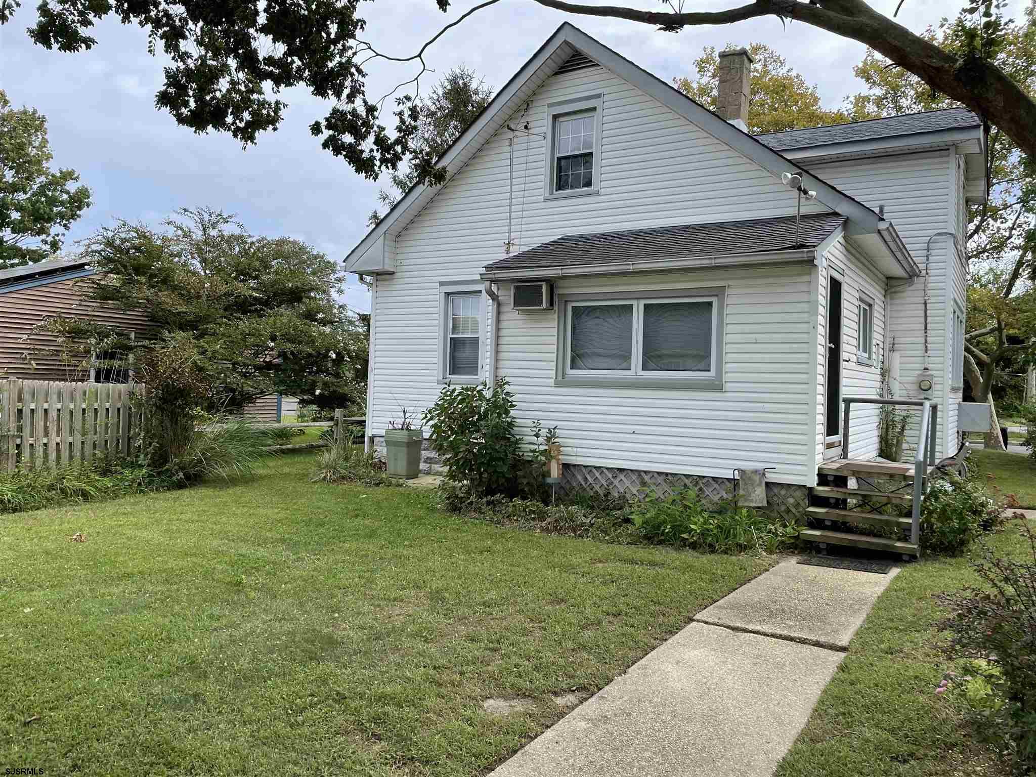 613 3rd Street Somers Point, NJ 08244 - Photo 4 of 22 a front view of a house with a garden