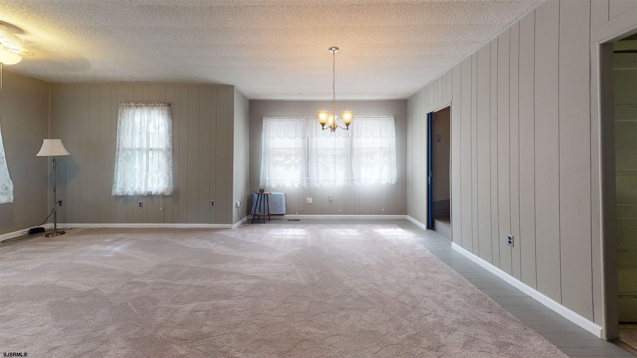 613 3rd Street Somers Point, NJ 08244 - Photo 8 of 22 an empty room with window and chandelier fan