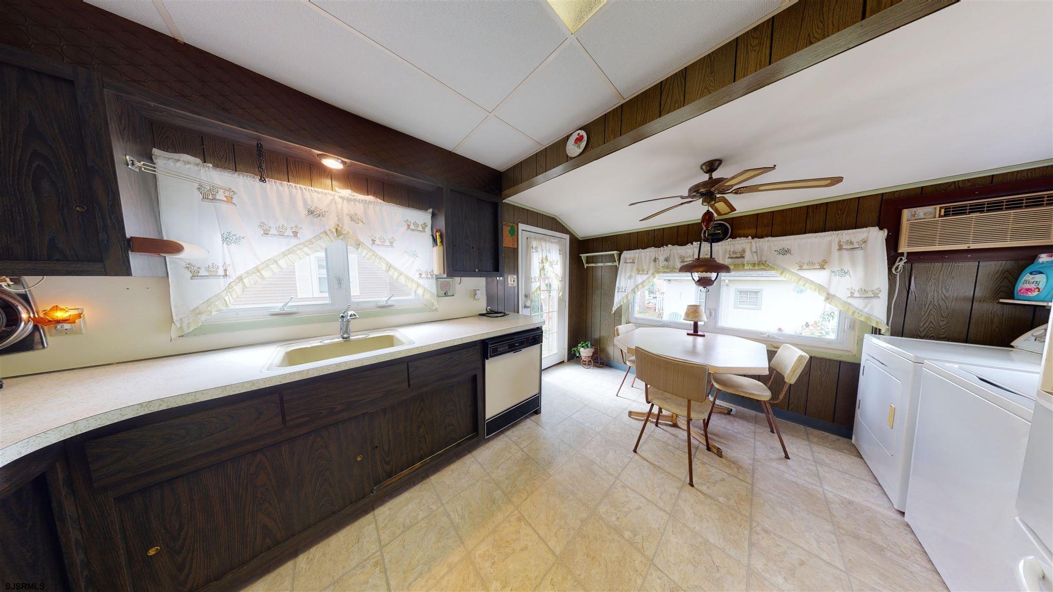 613 3rd Street Somers Point, NJ 08244 - Photo 9 of 22 a large white kitchen with a large window