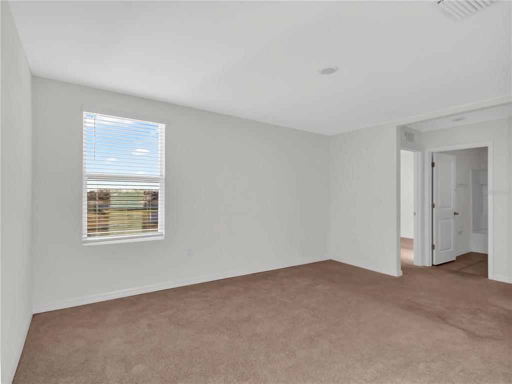 16645 Mosaic Oar Drive Wimauma, FL 33598 - Photo 17 of 43 a view of an empty room with a window
