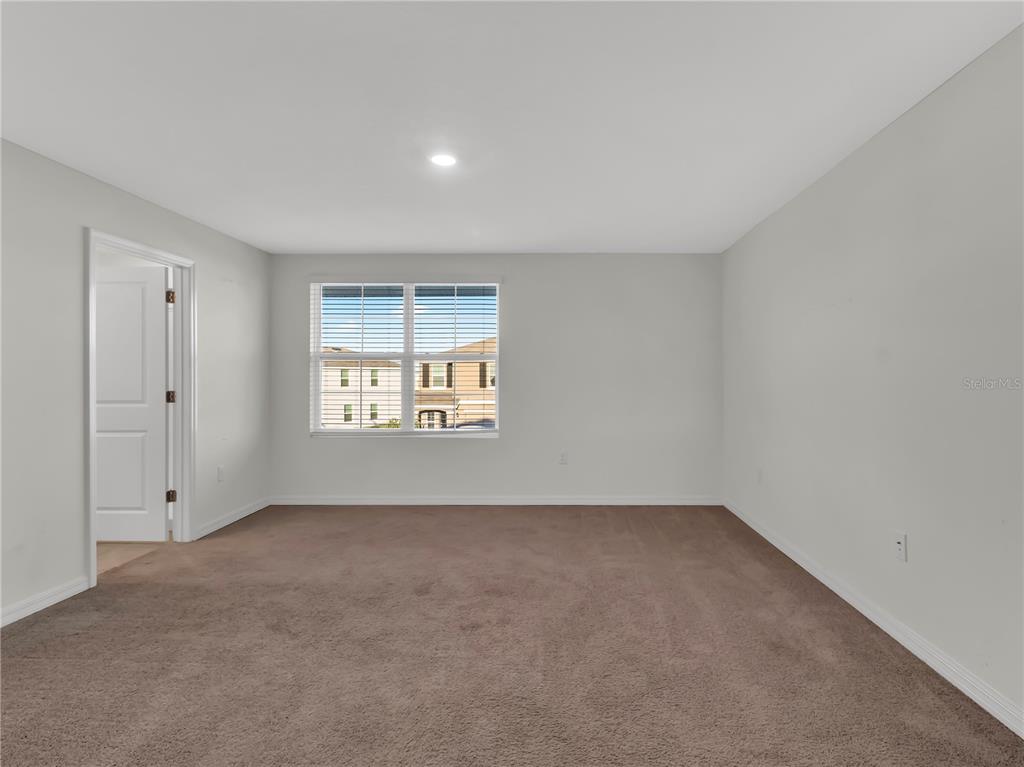 16645 Mosaic Oar Drive Wimauma, FL 33598 - Photo 24 of 43 a view of an empty room with a window