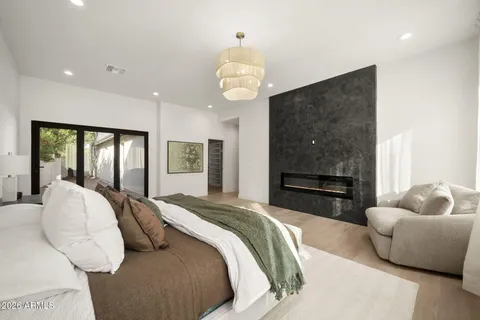a bedroom with a bed ceiling fan and a window