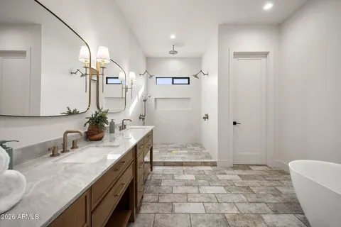 a bathroom with a sink a toilet and mirror