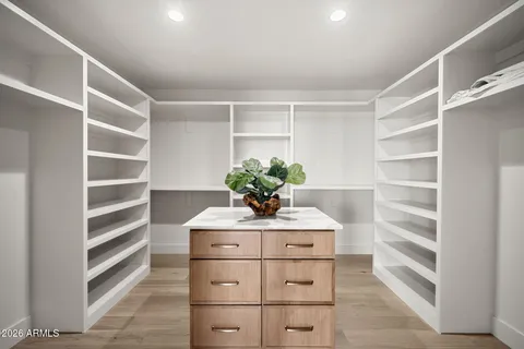 a kitchen with a refrigerator and white cabinets