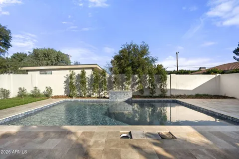 a view of a swimming pool with a yard