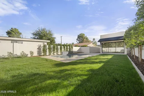 a view of a house with a yard and a fountain