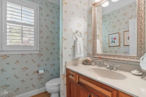 a kitchen with stainless steel appliances kitchen island a table and chairs