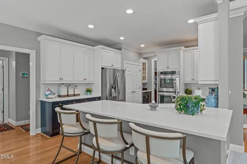 a bedroom with bed tv and a window