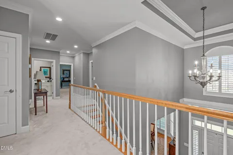 a kitchen with stainless steel appliances granite countertop a stove top oven a sink dishwasher and white cabinets with wooden floor