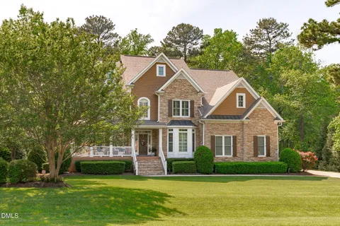 a view of an entryway with wooden floor and a livingroom